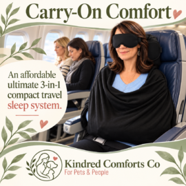 Woman seated on an airplane wearing a black eye mask, padded head support, and blanket-like body sling. Image reads “Carry-On Comfort” and features the Kindred Comforts Co. logo.